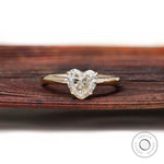 Front view heart shaped solitaire ring on rustic wooden background