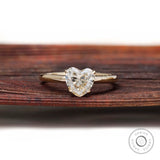 Front view heart shaped solitaire ring on rustic wooden background