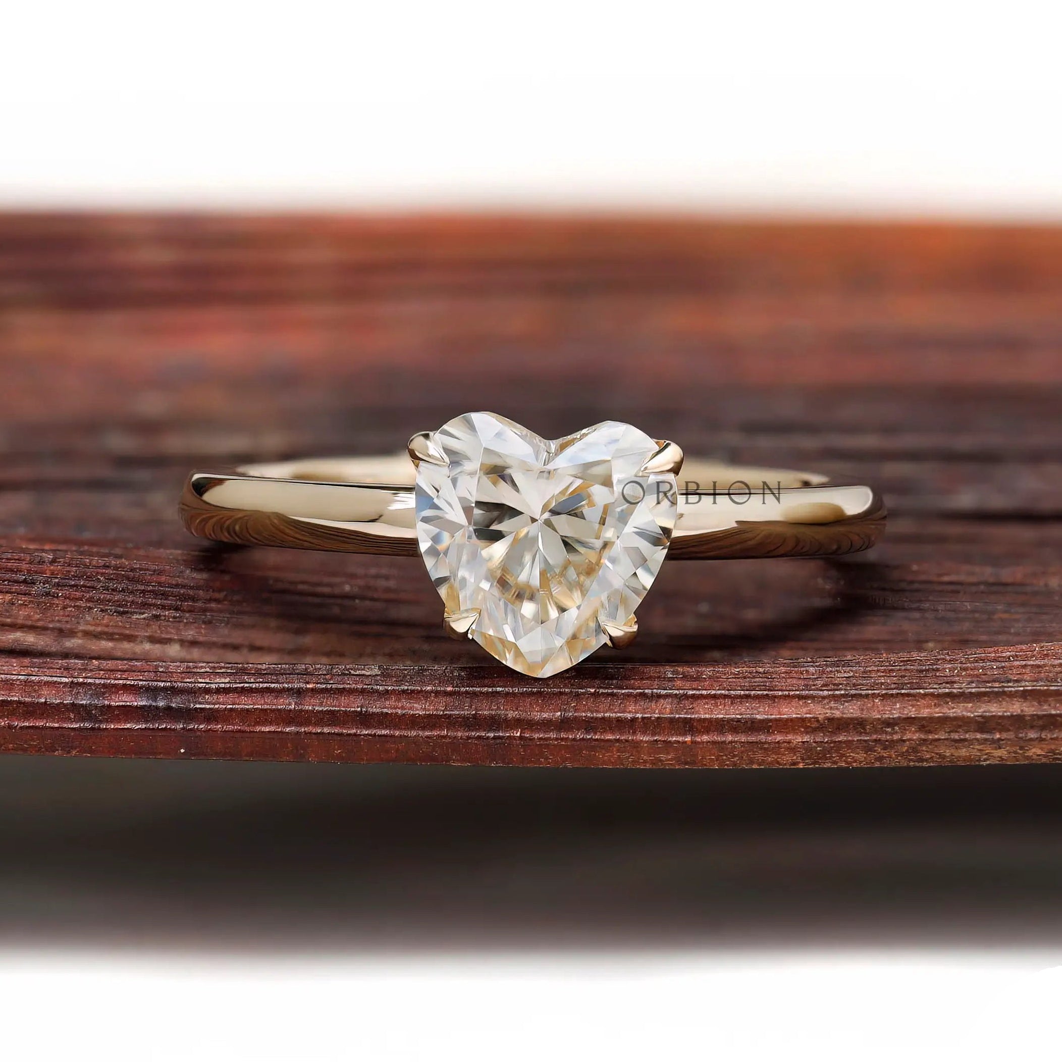 Front view heart shaped solitaire ring on rustic wooden background