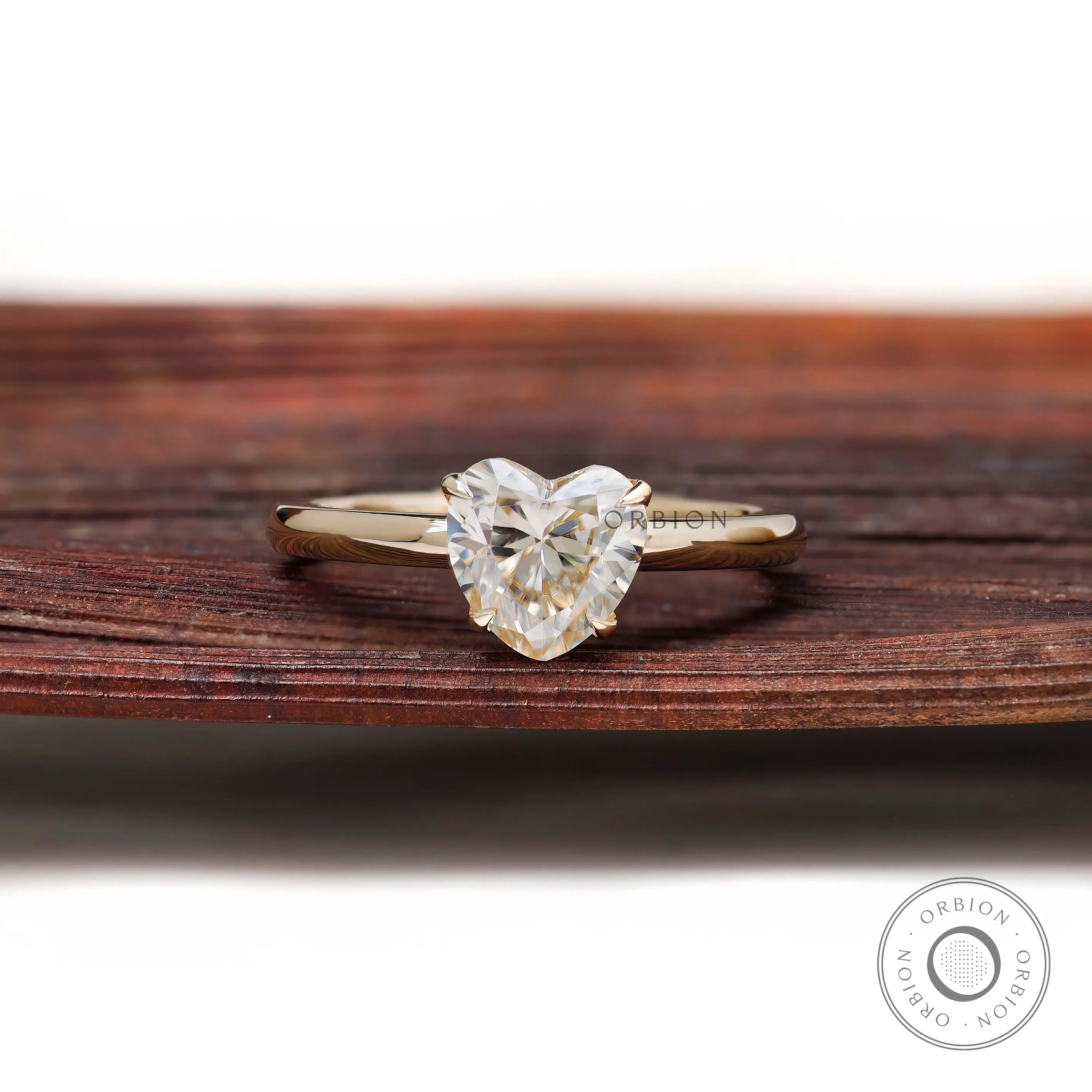 Front view heart shaped solitaire ring on rustic wooden background