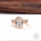 Elongated cushion Old Mine Cut moissanite bezel ring in rose gold front view