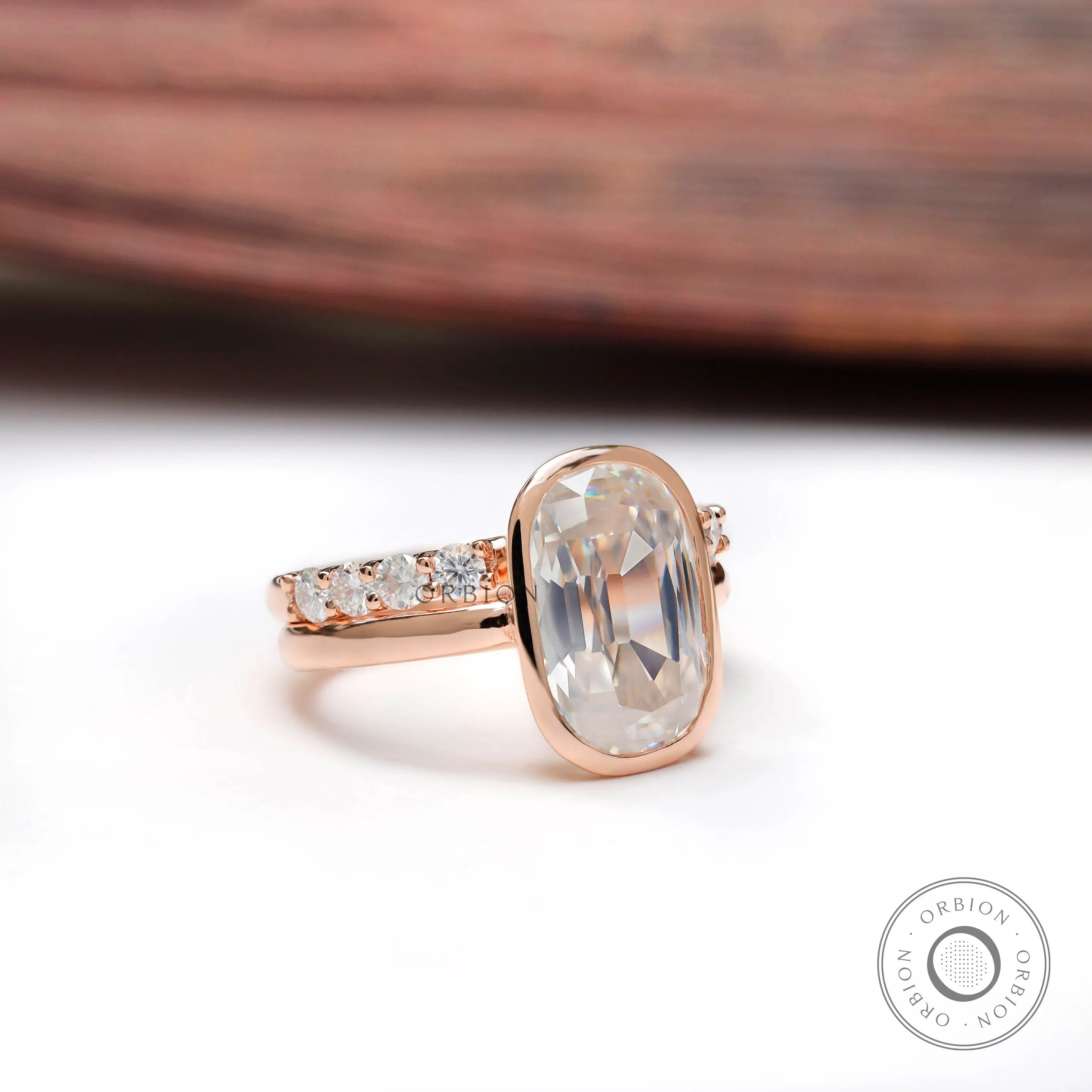 Angled view of elongated cushion moissanite ring with side stones