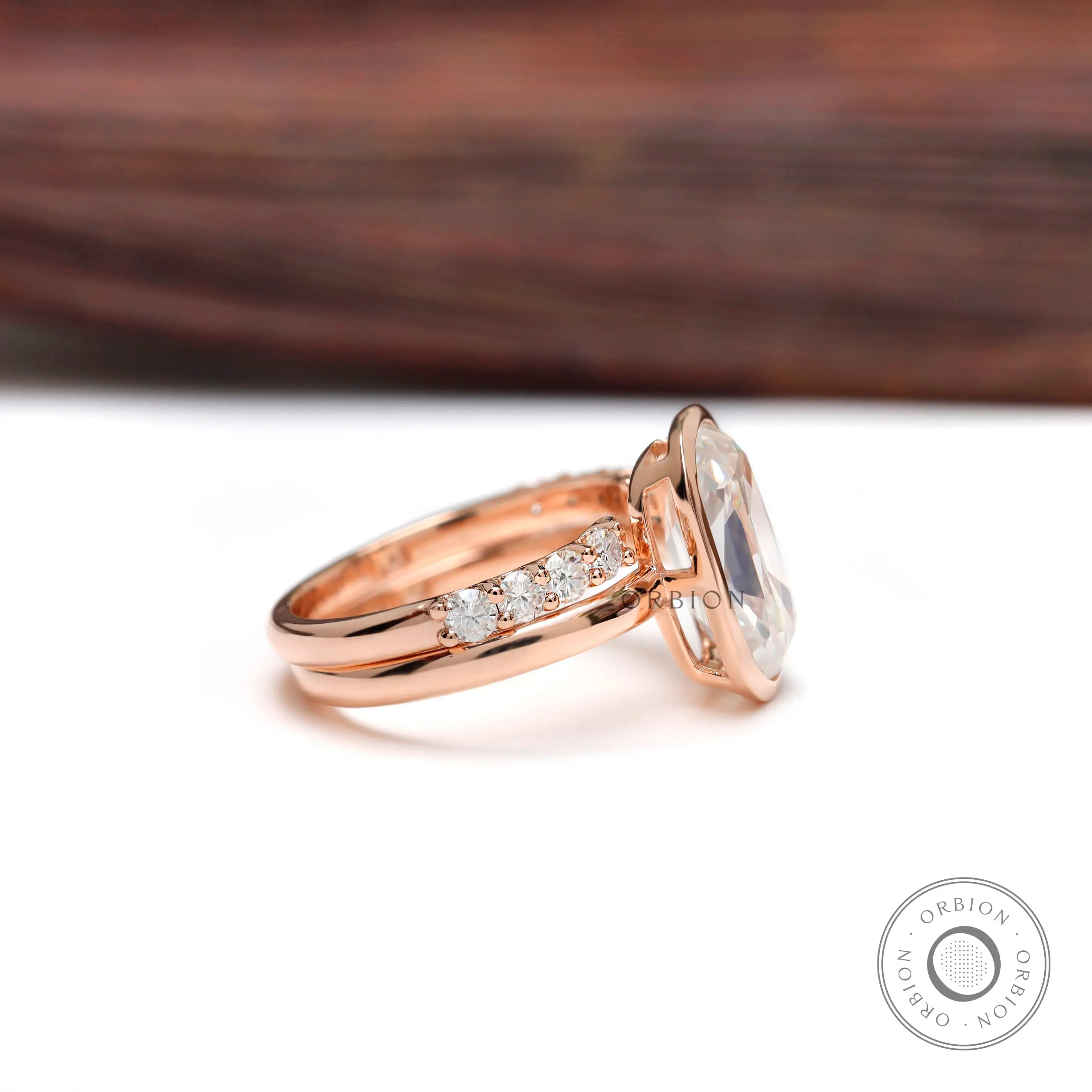 Side profile of bezel set moissanite ring in 10K rose gold