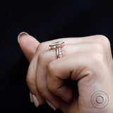 Profile view highlighting side stone detailing on rose gold band
