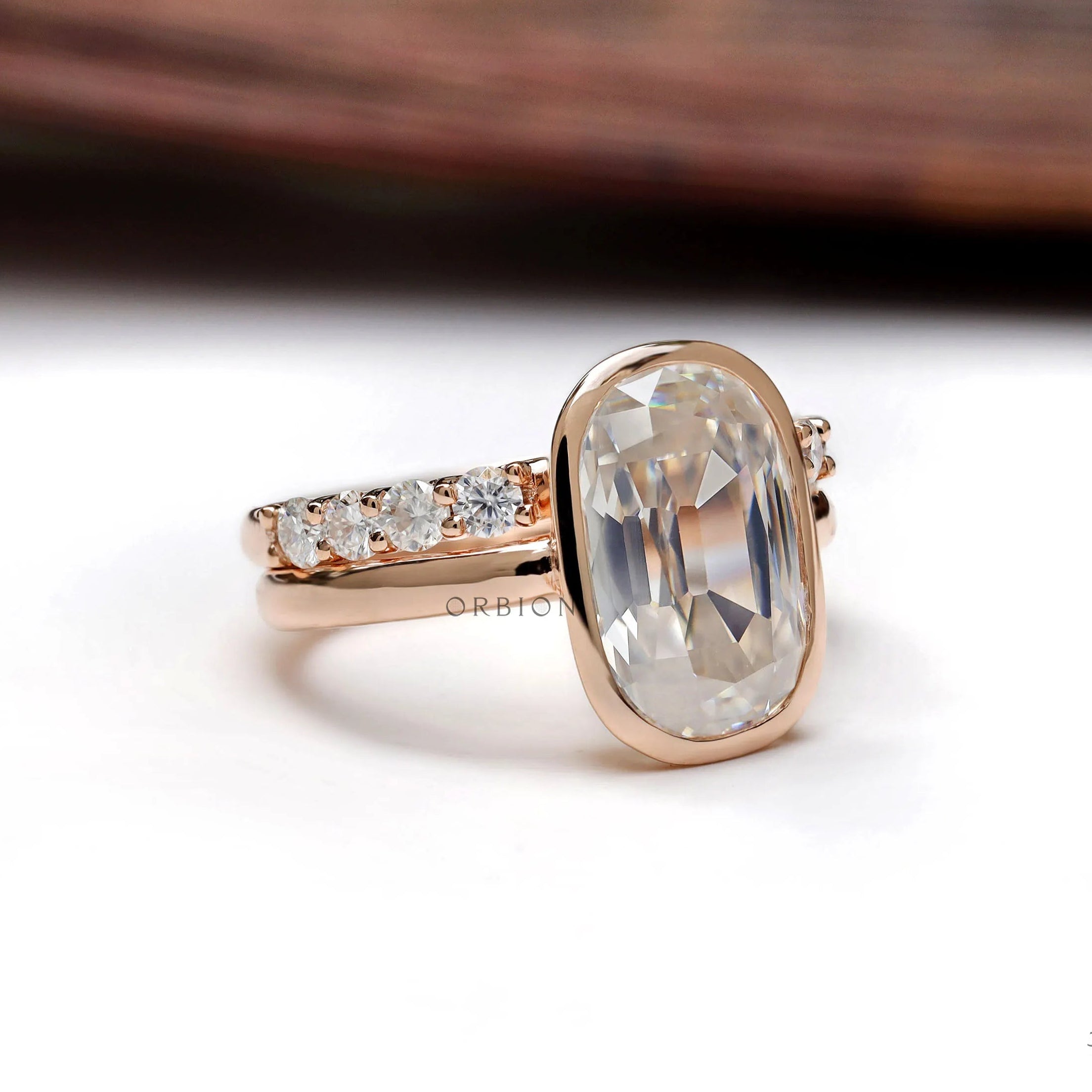 Angled view of elongated cushion moissanite ring with side stones