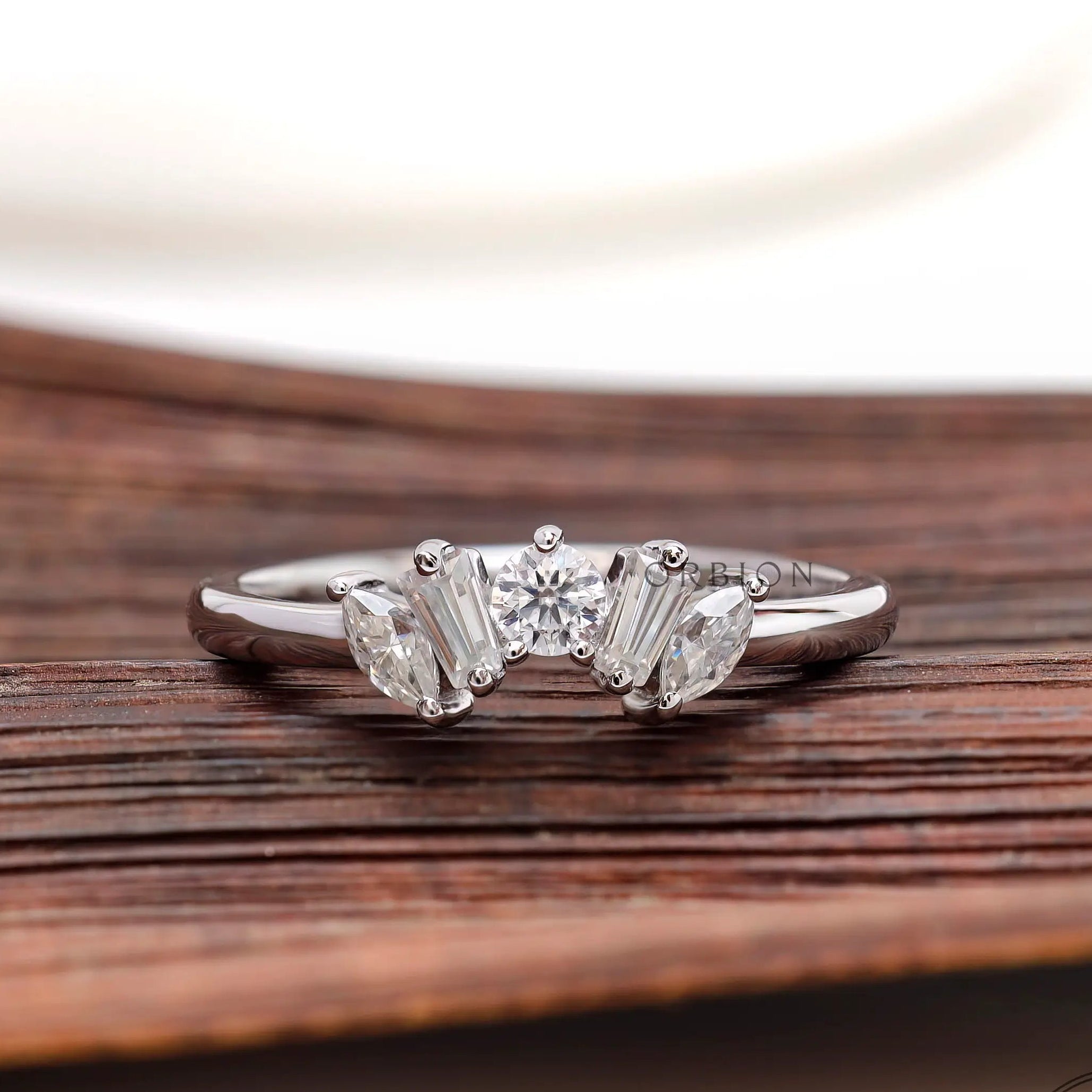 Front view of curved multi stone moissanite band
