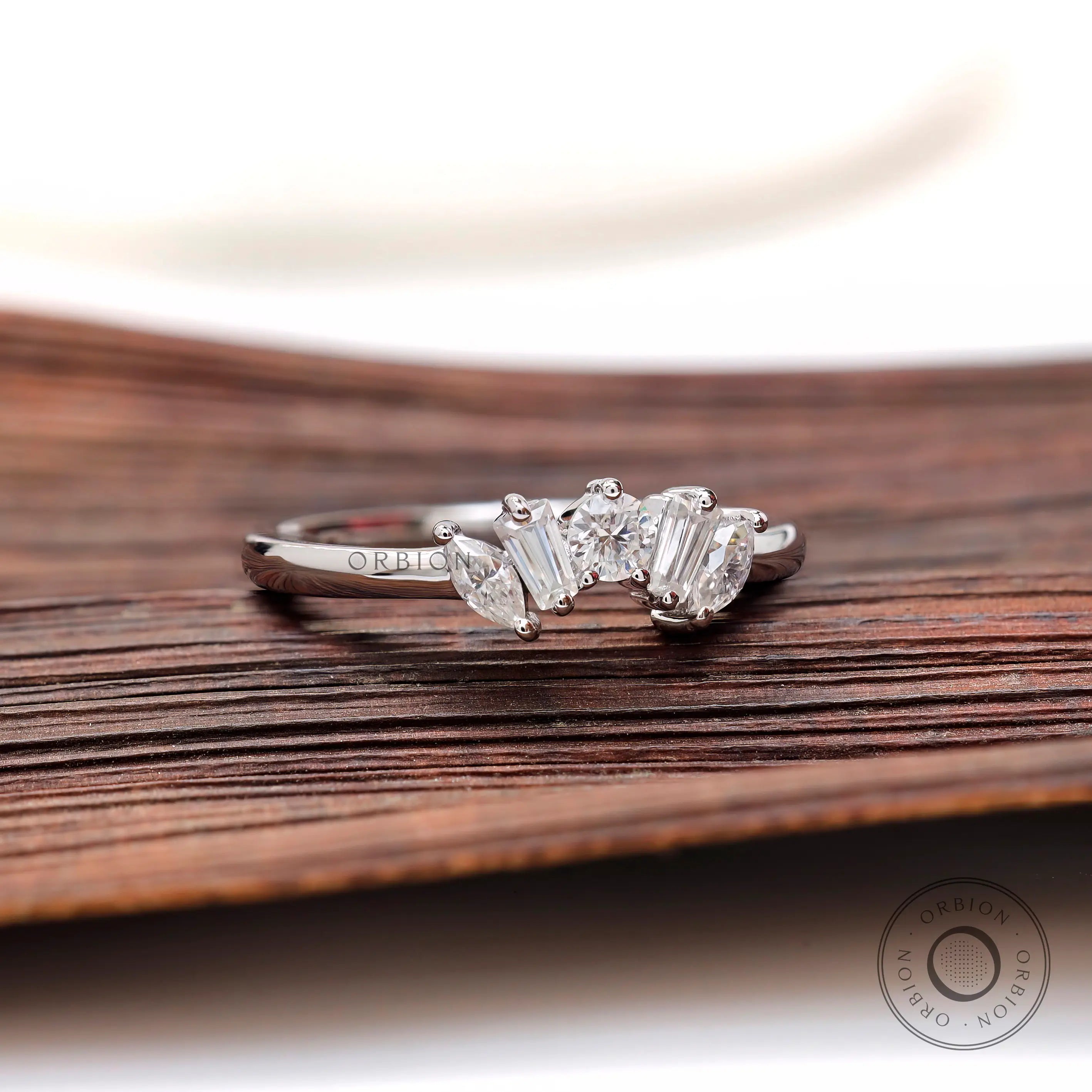 Angled view of mixed shape moissanite curve