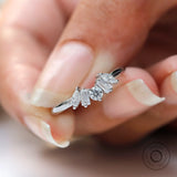 Close-up of multi stones moissanite with glossy white gold band finish