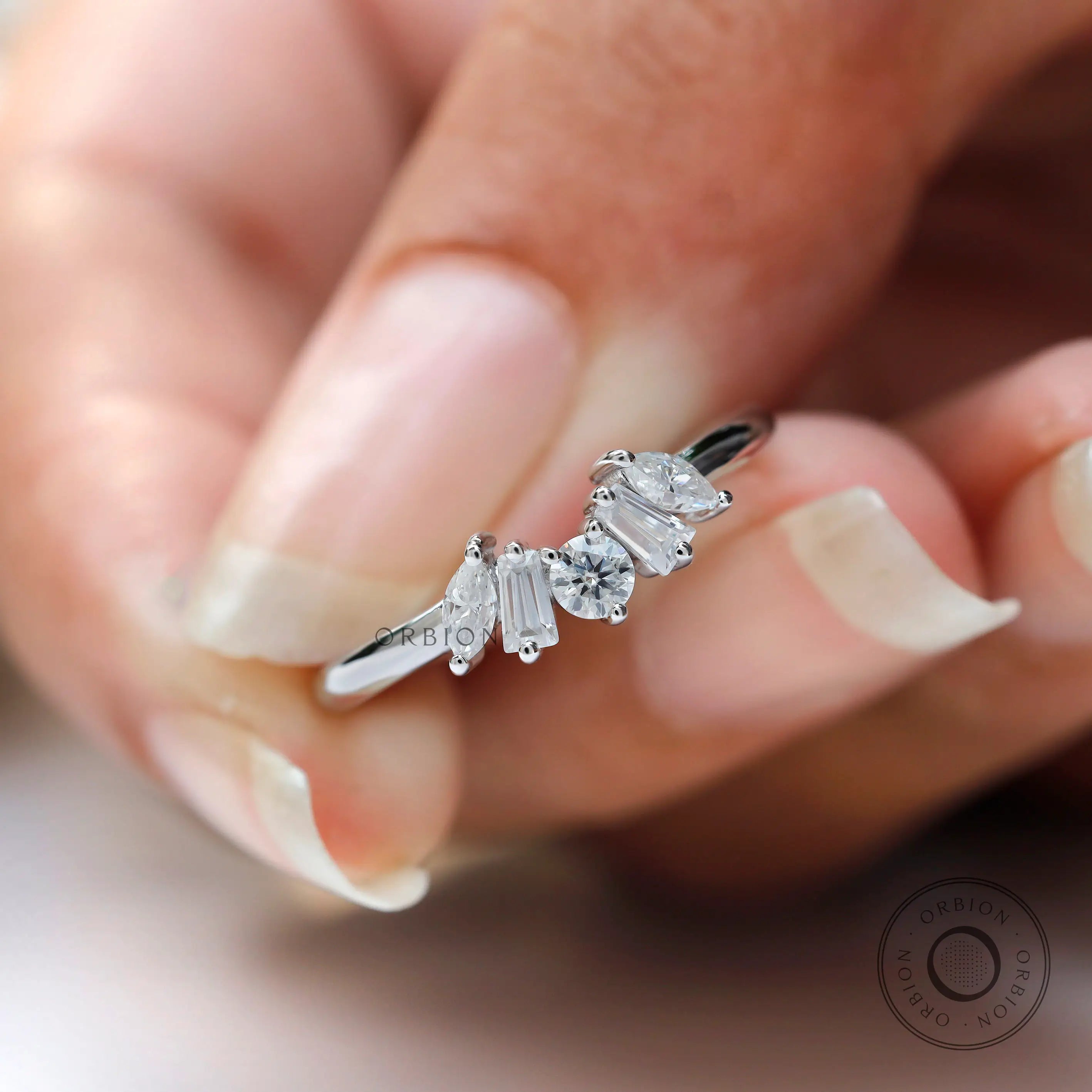 Close-up of multi stones moissanite with glossy white gold band finish