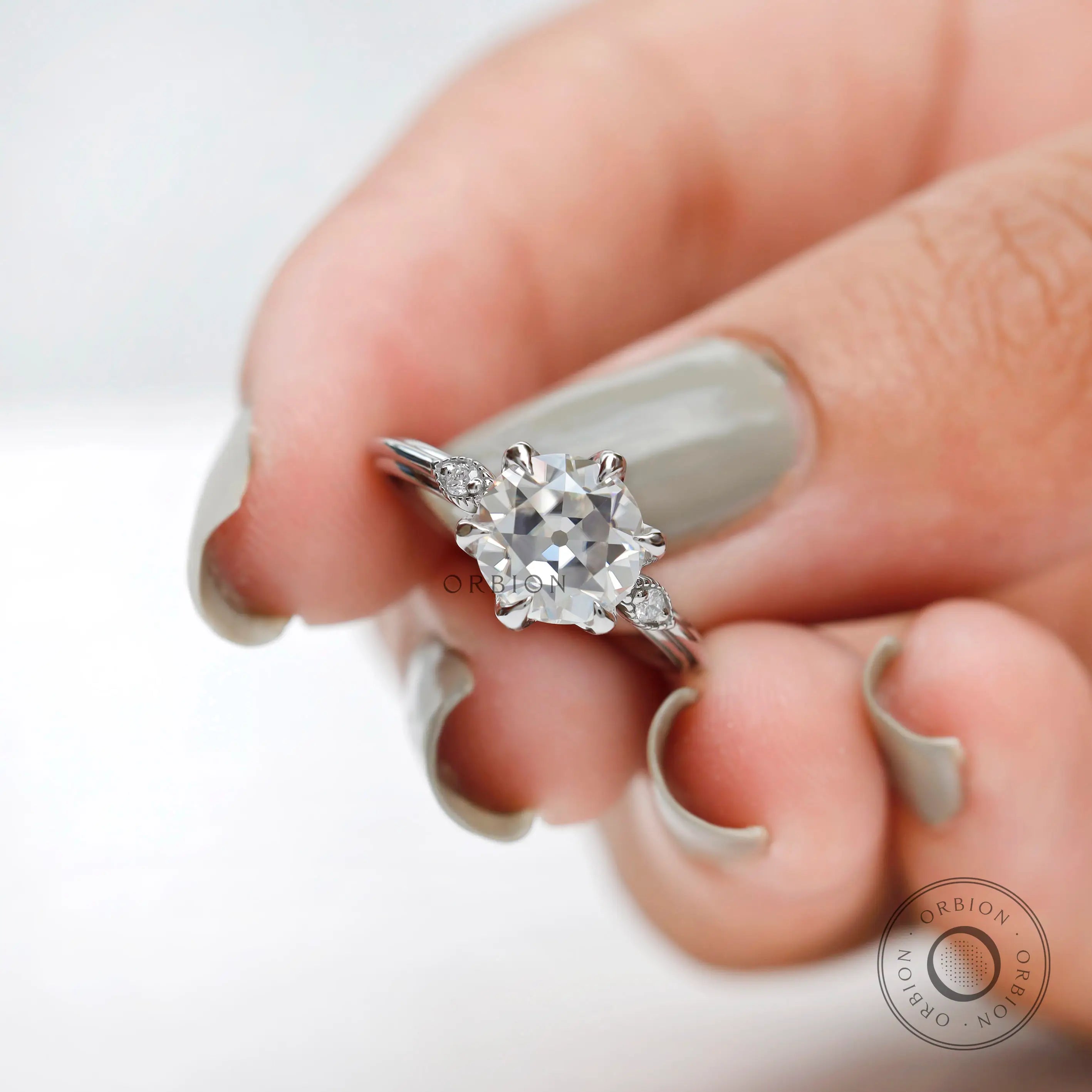Angled view emphasizing milgrain and classic setting