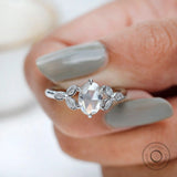 Angled view oval rose cut cluster ring design