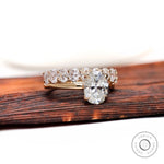 Oval moissanite solitaire with matching stack band front view