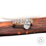 Oval moissanite solitaire with matching stack band front view