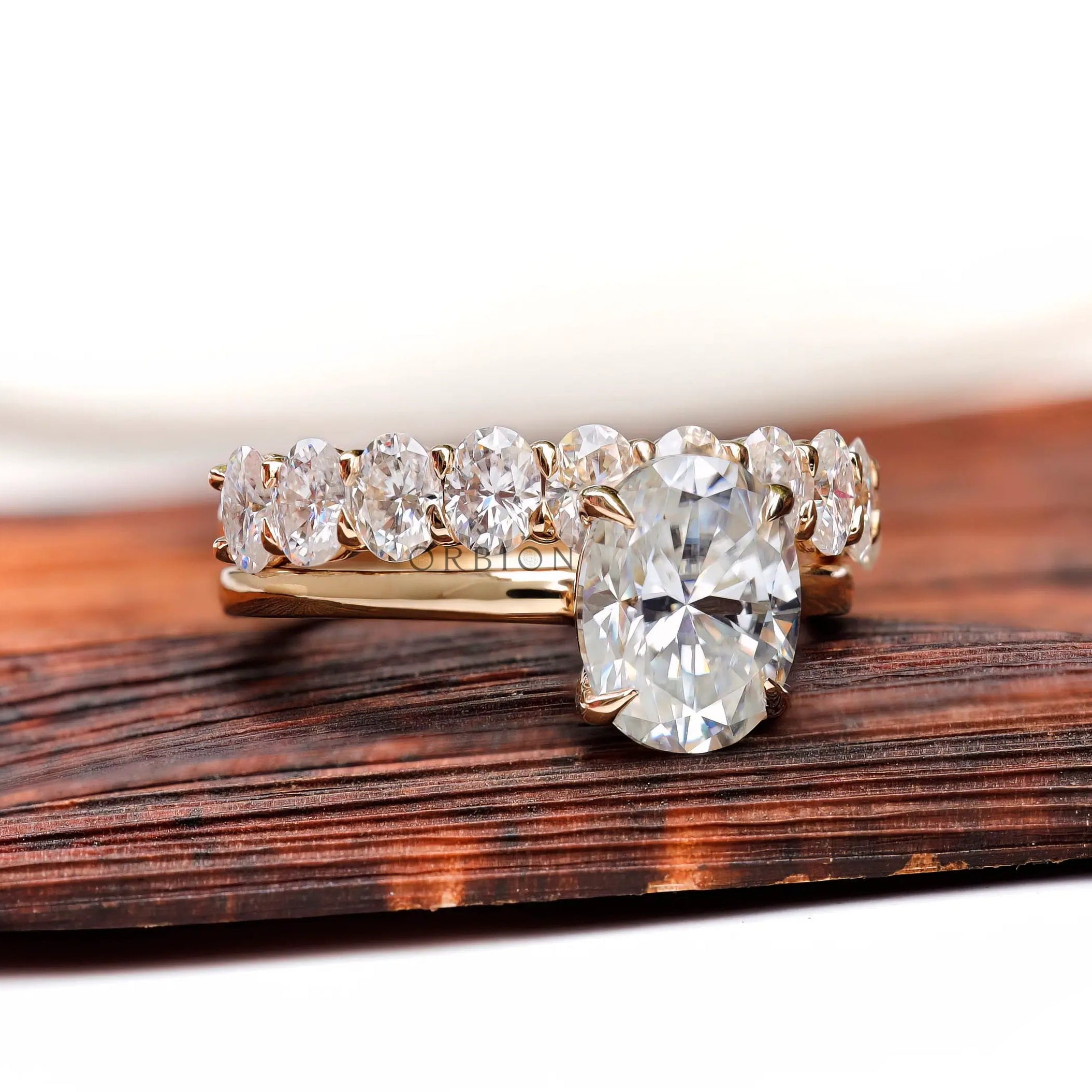 Oval moissanite solitaire with matching stack band front view