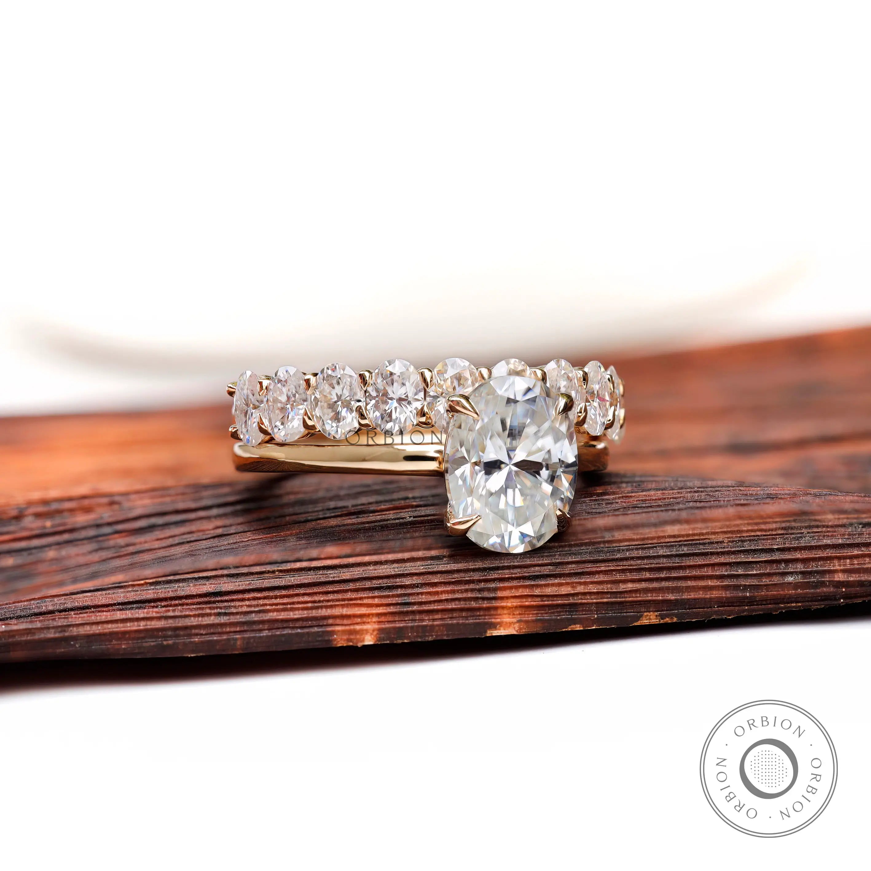 Oval moissanite solitaire with matching stack band front view