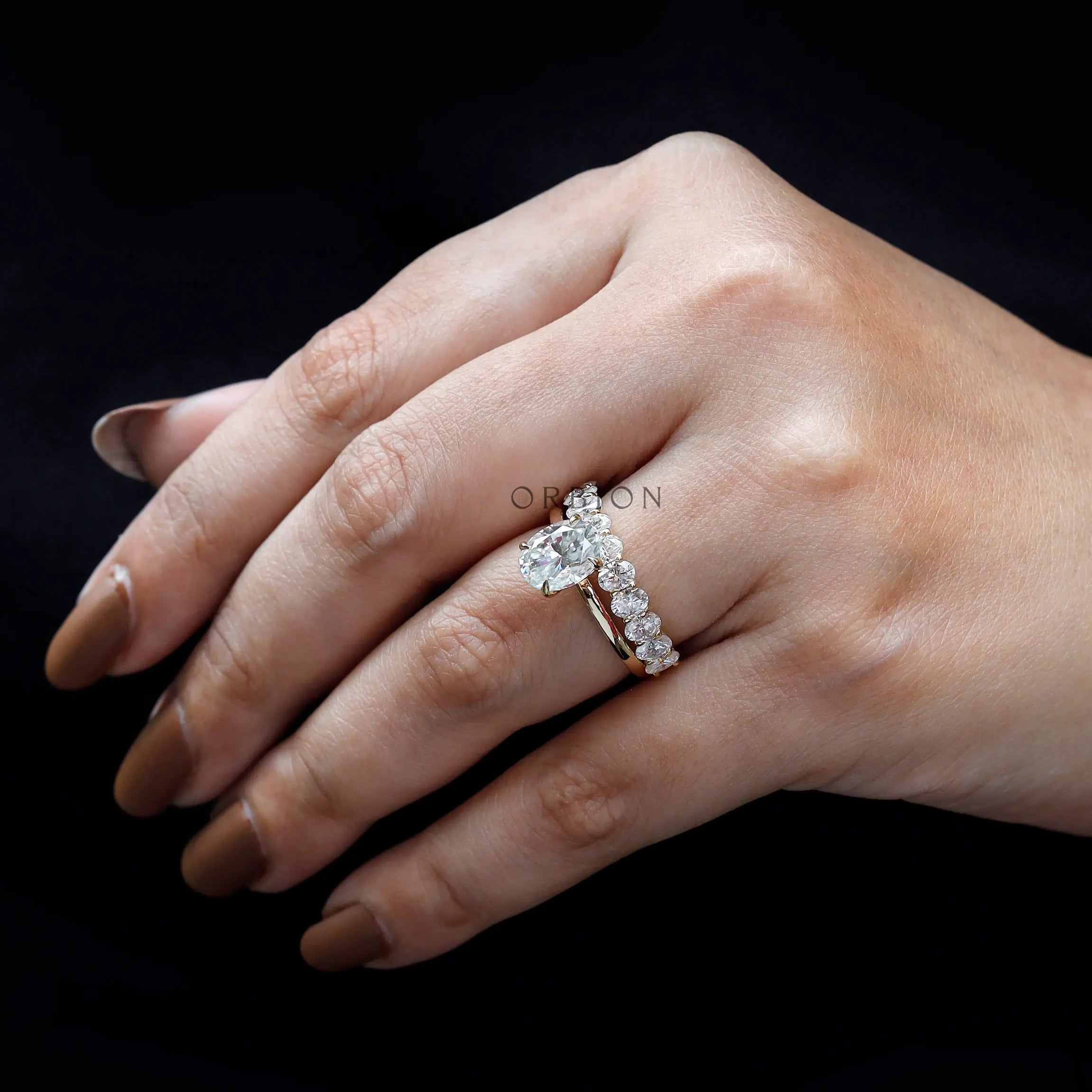 Close-up view of oval moissanite stones on band