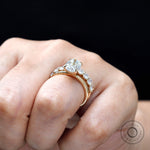 On hand view showing oval solitaire and stack band