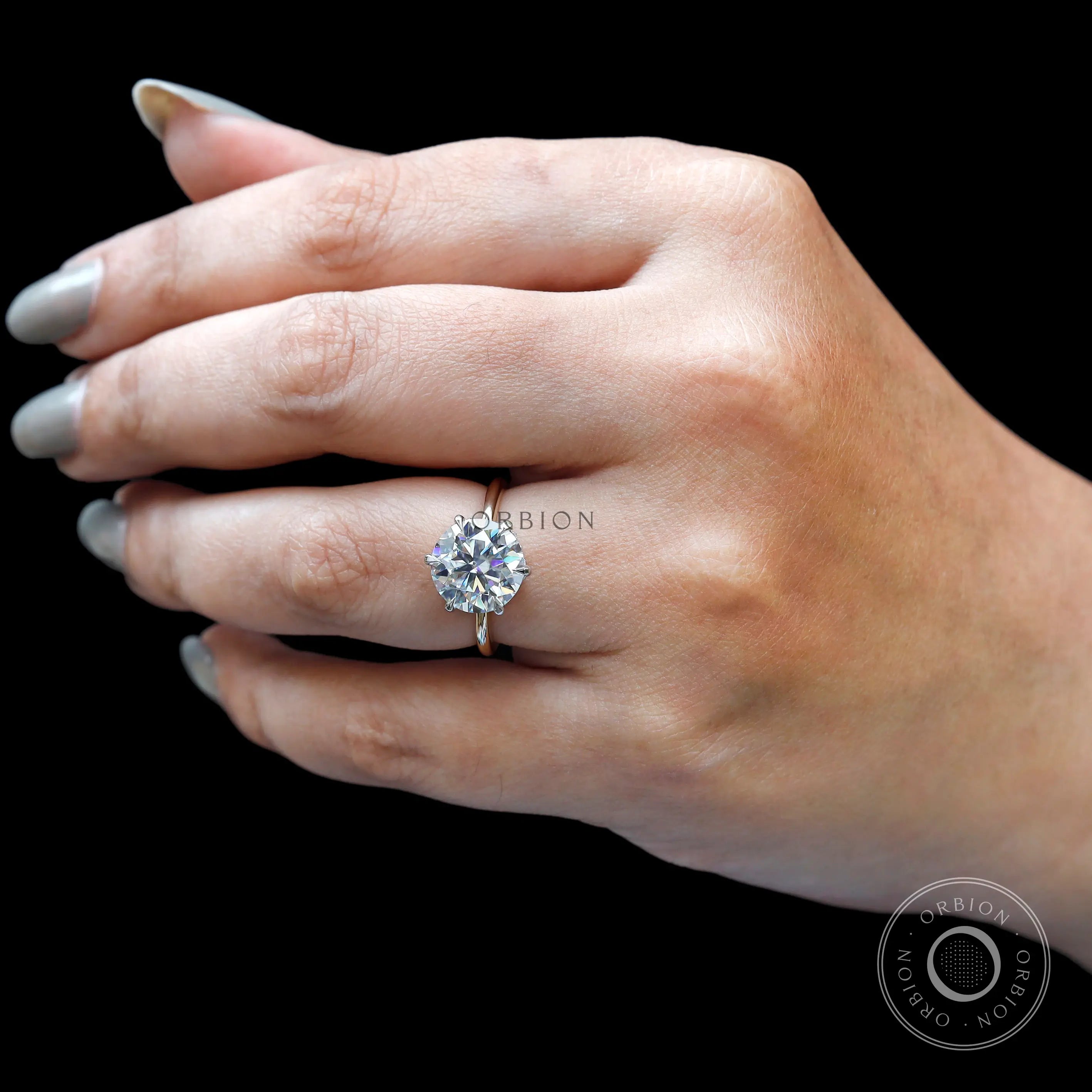Angled on-hand view polished gold solitaire ring