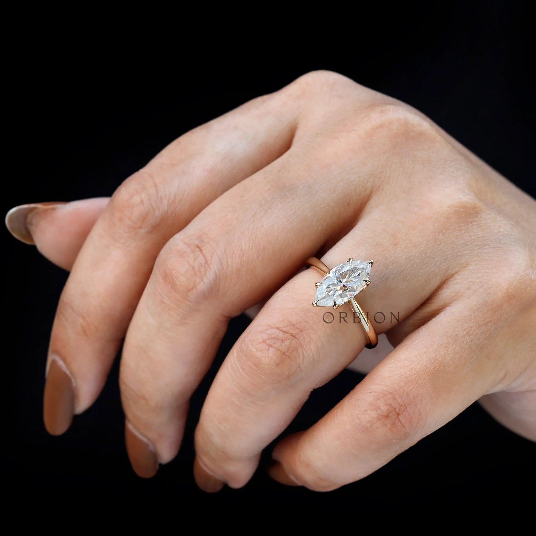 Close up marquise lab diamond engagement ring on fingure