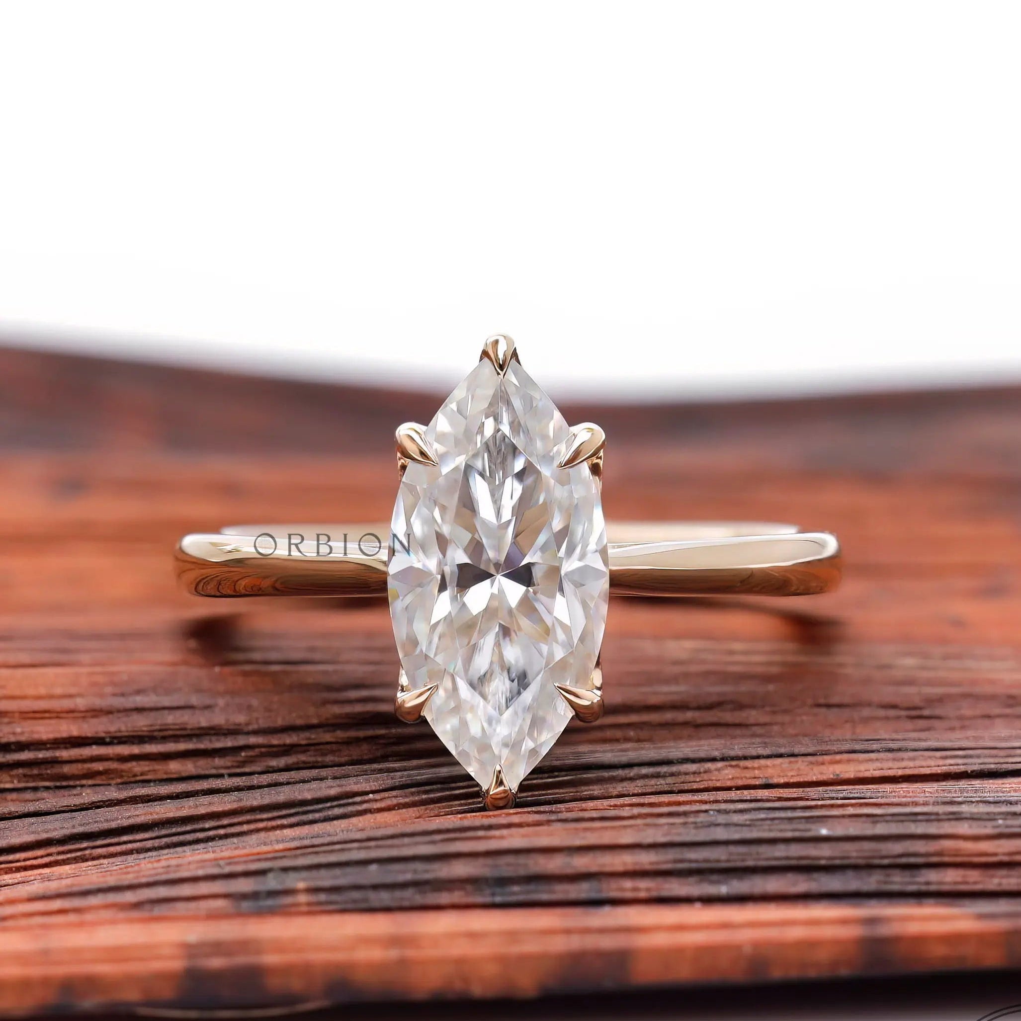 Marquise cut moissanite solitaire engagement ring in 14K yellow gold