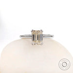 Front view emerald cut moissanite solitaire ring on white stone in white gold