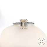 Front view emerald cut moissanite solitaire ring on white stone in white gold