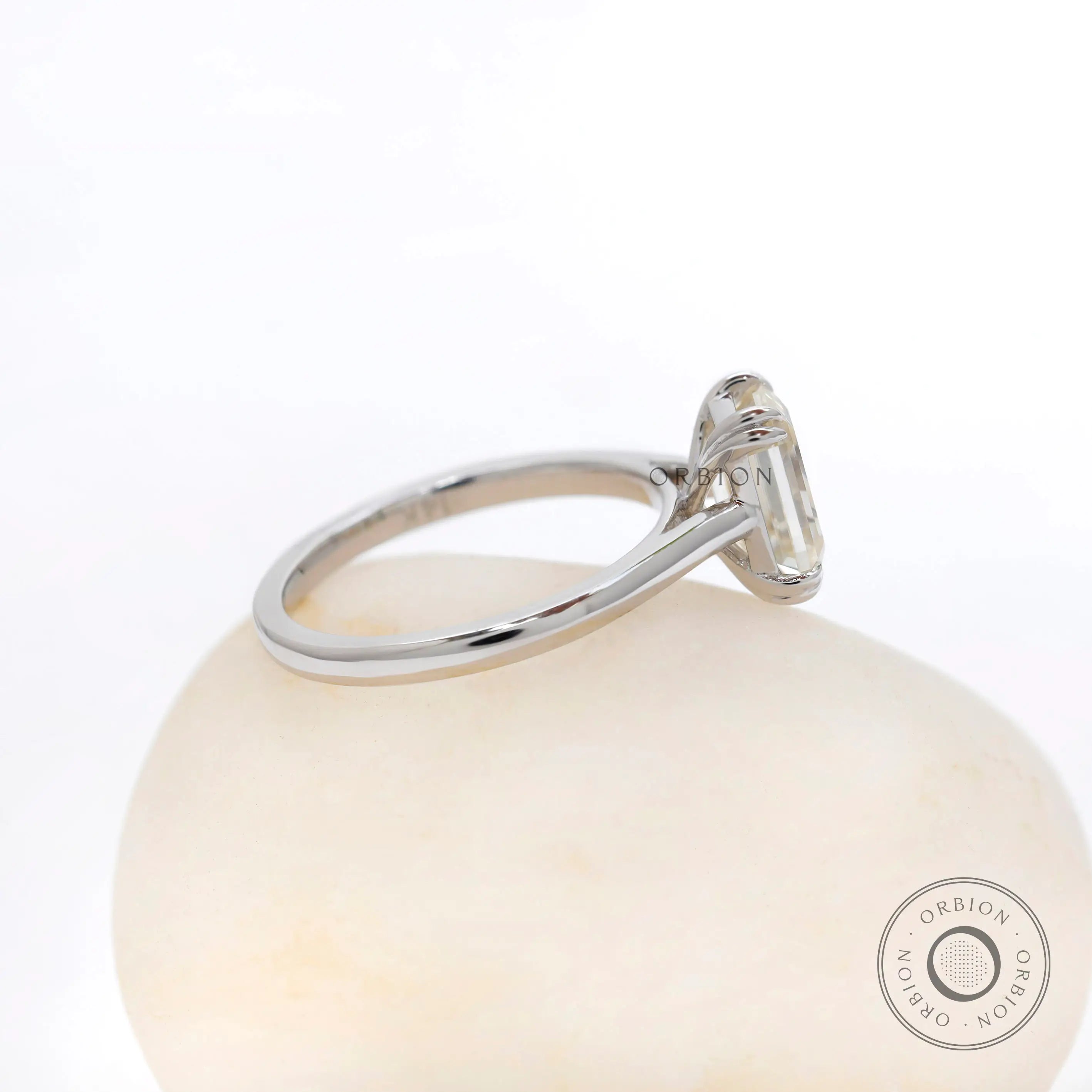 Side profile view highlighting cathedral setting and raised basket in white gold