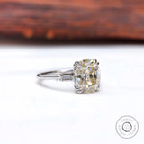 Angled view of cushion moissanite with baguette sides in white gold.