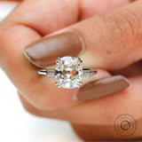Close-up top view double claw prongs on cushion moissanite.