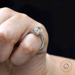 On-hand side view three-stone ring with baguette accents.