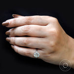 On-hand side view three-stone ring with baguette accents.