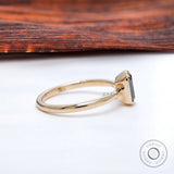 Low profile bezel setting on slim polished yellow gold band.