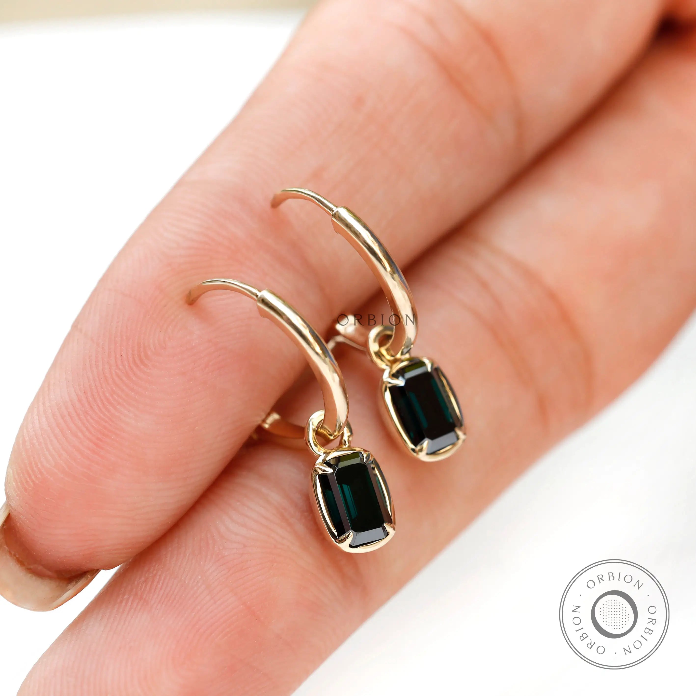 Dark green gemstone drop earrings with glossy gold finish