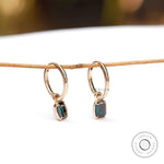 Dark green emerald cut moissanite huggie hoop drop earrings in 10K yellow gold