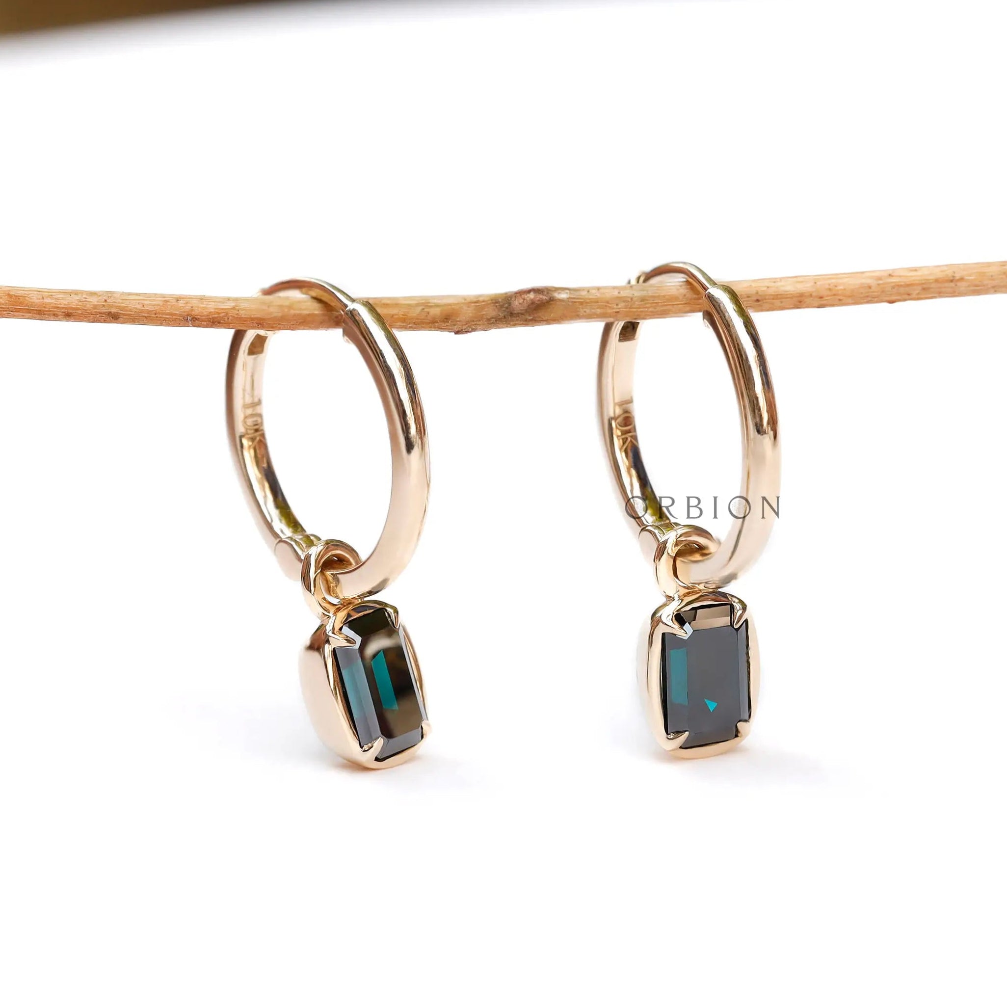 Dark green emerald cut moissanite huggie hoop drop earrings in 10K yellow gold