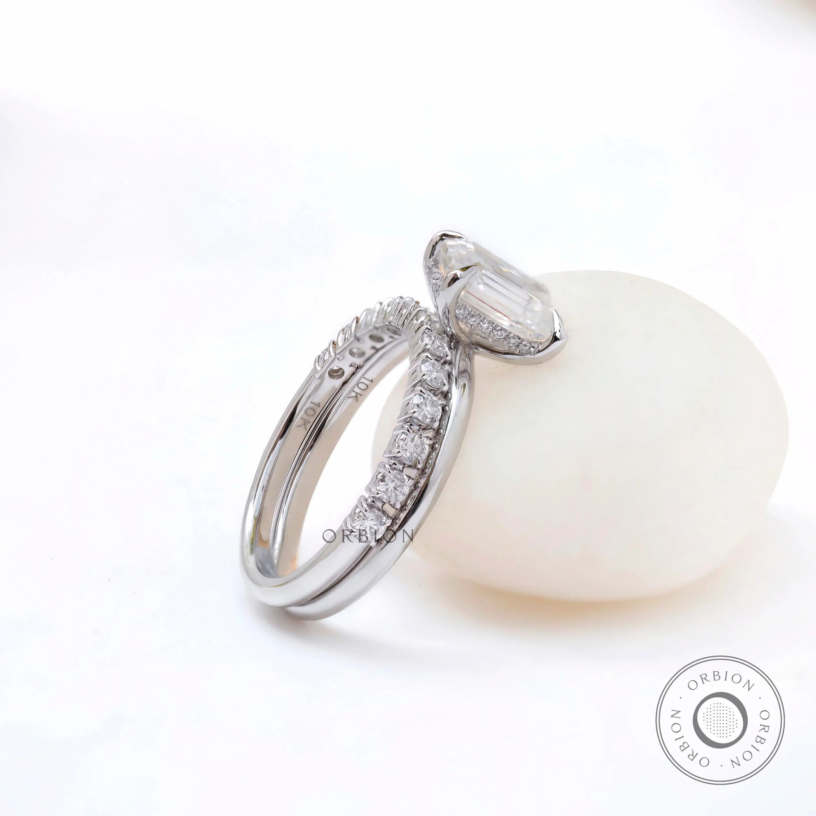 White gold emerald cut ring with pavé band detail