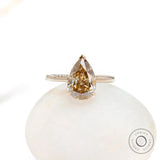 Front view of pear solitaire hidden halo ring in gold