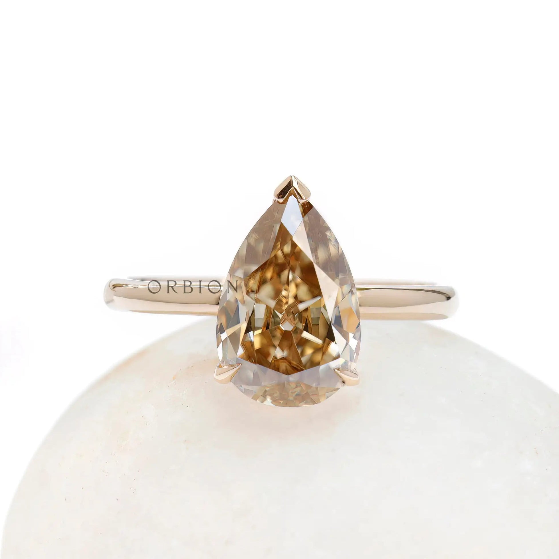 Front view of pear solitaire hidden halo ring in gold