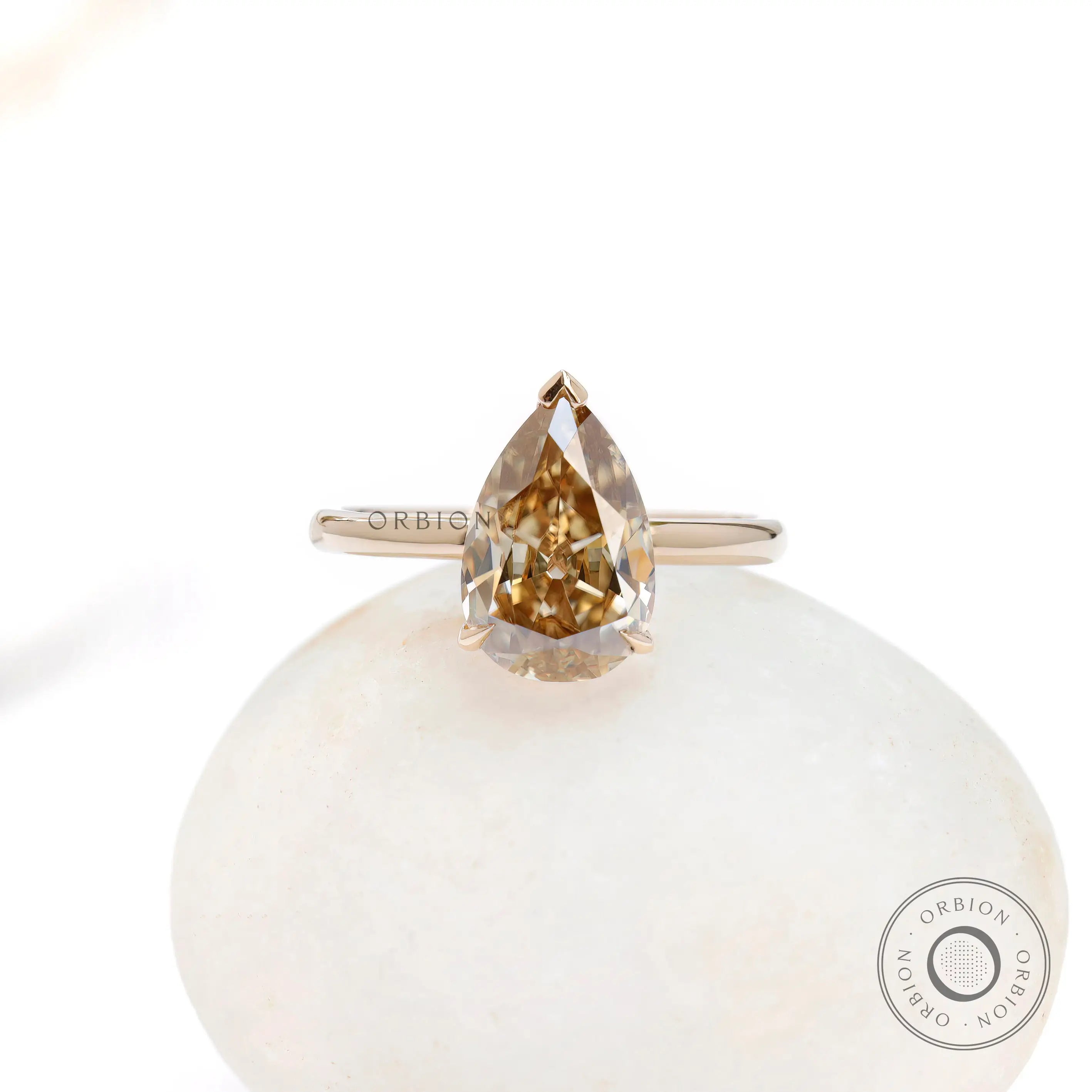 Front view of pear solitaire hidden halo ring in gold