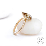 Angled back view of pear hidden halo ring in gold