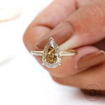 Close-up front view of pear solitaire hidden halo ring