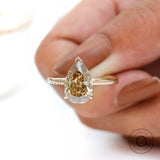 Close-up front view of pear solitaire hidden halo ring