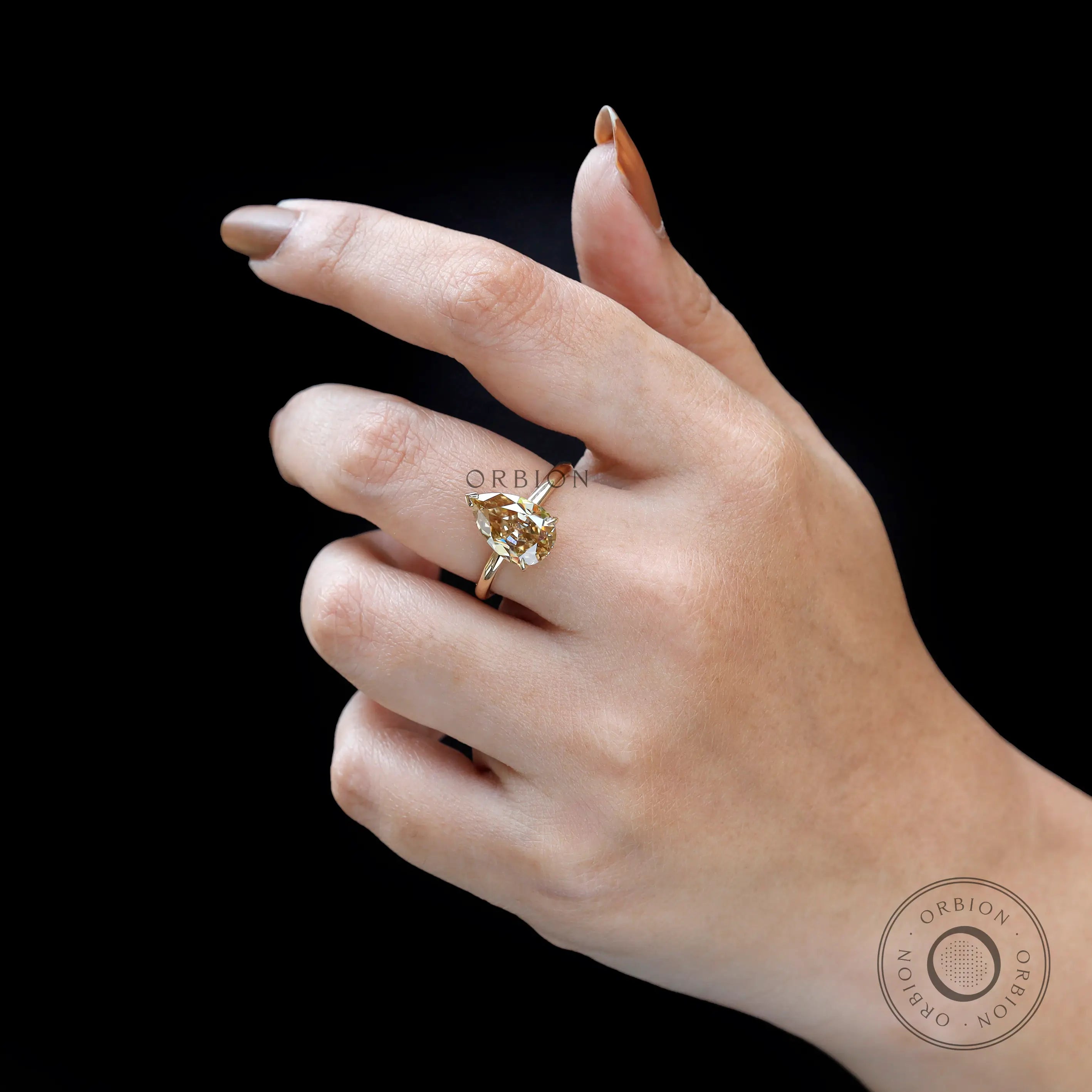 Angled worn view of pear solitaire hidden halo ring