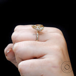 Side worn profile of pear hidden halo engagement ring
