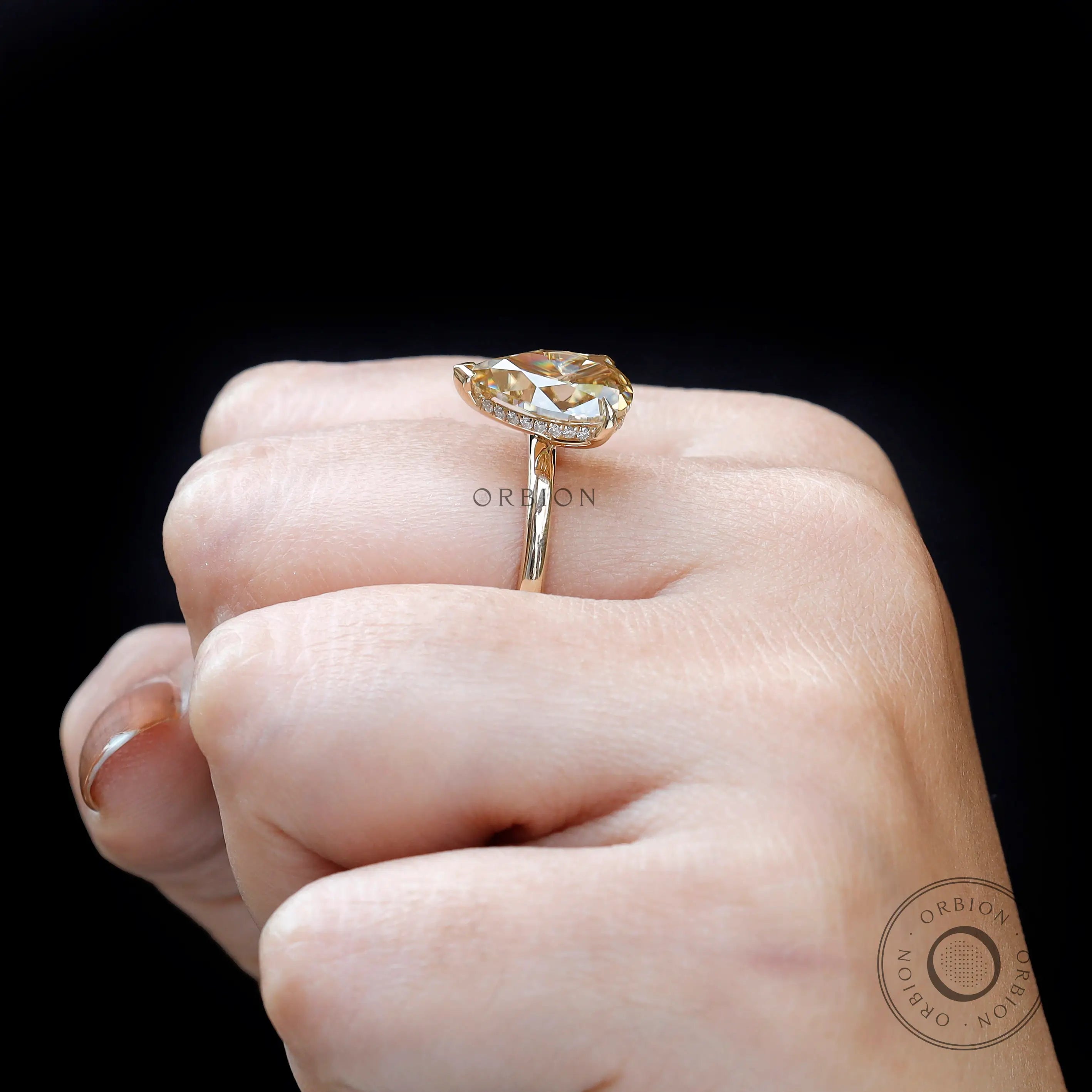 Side worn profile of pear hidden halo engagement ring