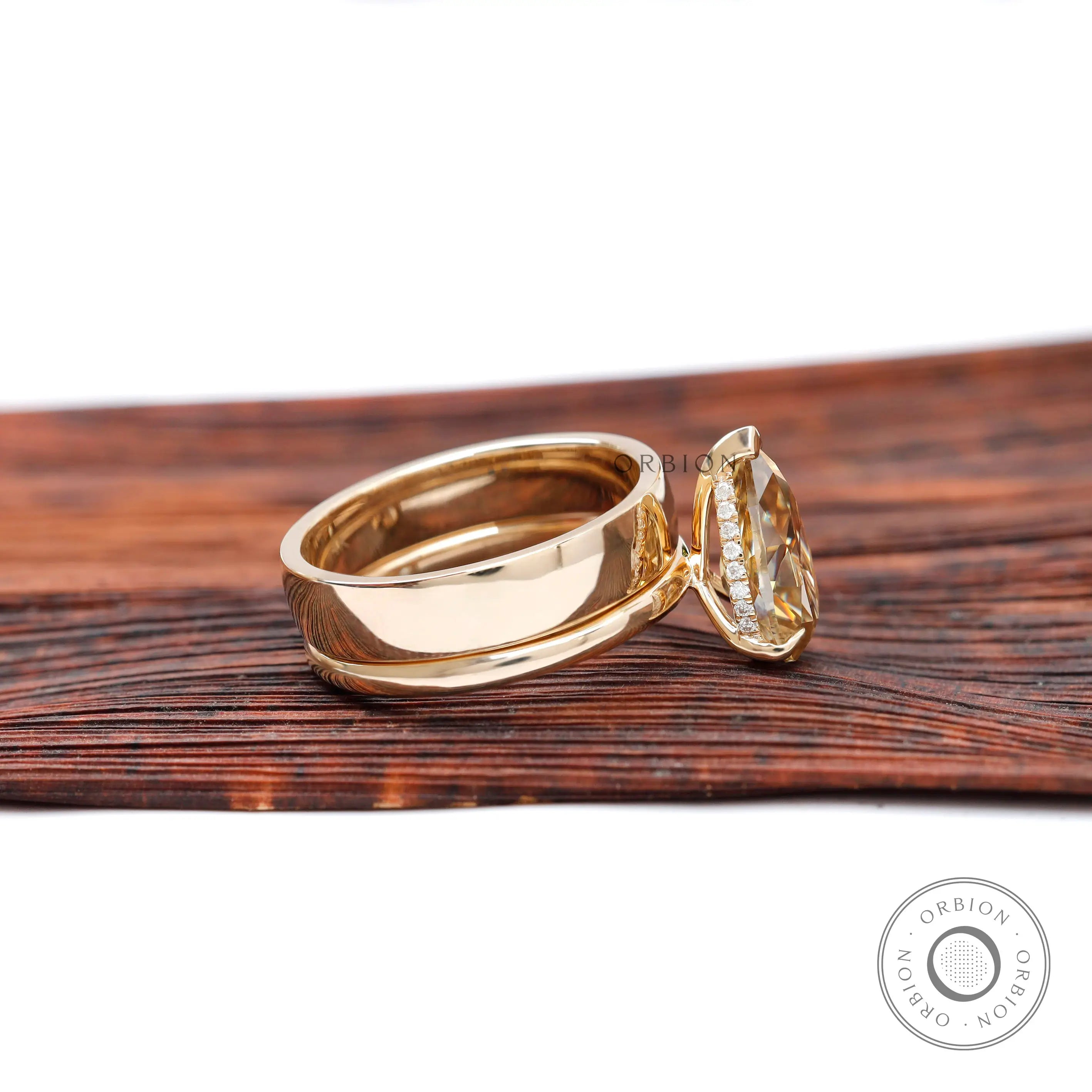 Side profile of pear champagne moissanite solitaire ring showing hidden halo