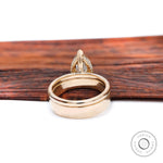 Rear view of pear moissanite solitaire ring with solid gold band