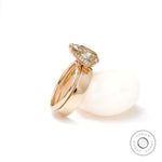Angled view highlighting hidden halo beneath pear moissanite center stone