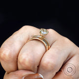 Side view of pear moissanite solitaire ring worn on hand