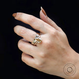 Close-up of pear champagne moissanite solitaire ring with stacked band
